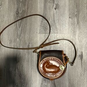 Like new Dooney & Burke small leather cross body purse. Brown & dark brown.